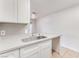 Kitchen with white cabinetry, stainless steel sink, and view to the living space at 5101 Renault Ave, Las Vegas, NV 89142