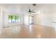 Spacious living area with tile floors, a ceiling fan, and sliding glass doors to the patio at 5101 Renault Ave, Las Vegas, NV 89142
