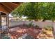 Relaxing outdoor patio with brick pavers and privacy wall, shaded by a mature tree at 5101 Renault Ave, Las Vegas, NV 89142