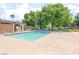 Sparkling community pool with ample seating, a covered area, and mature trees at 5101 Renault Ave, Las Vegas, NV 89142