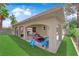 Spacious backyard featuring artificial grass, splash pad and a covered patio perfect for outdoor living at 5228 Harmony Ave, Las Vegas, NV 89107