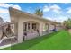 Spacious covered patio featuring comfortable seating and a splash pad, perfect for Gathering fun in the backyard at 5228 Harmony Ave, Las Vegas, NV 89107