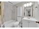 Functional bathroom featuring a shower-tub combo, single sink vanity, medicine cabinet and modern fixtures at 5228 Harmony Ave, Las Vegas, NV 89107