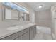 Modern bathroom featuring double vanity, updated fixtures, and soaking tub with tiled surround at 5228 Harmony Ave, Las Vegas, NV 89107