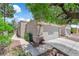 Exterior view of a well-maintained property with lush landscaping and a two-car garage at 5228 Harmony Ave, Las Vegas, NV 89107