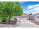 View of a well-manicured front yard and a two-car garage at 5228 Harmony Ave, Las Vegas, NV 89107
