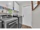 Bright laundry room features sleek washer/dryer, storage cabinets, and a clean, functional design at 5228 Harmony Ave, Las Vegas, NV 89107