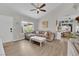 Bright living room featuring a neutral sofa, ceiling fan, and hardwood floors at 5228 Harmony Ave, Las Vegas, NV 89107