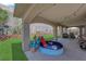 Covered patio area with artificial grass, splash pad, and string lights creating a playful outdoor space at 5228 Harmony Ave, Las Vegas, NV 89107