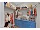 Bright walk-in closet featuring custom blue drawers, shelving and clothing rods for optimal storage at 5228 Harmony Ave, Las Vegas, NV 89107