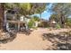 Extensive backyard includes patio, mature trees, and desert landscaping at 5381 Waving Sage Dr, Las Vegas, NV 89149