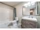 Bathroom with a vanity, framed mirror, tub, and toilet, creating a serene and functional space at 5381 Waving Sage Dr, Las Vegas, NV 89149