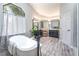 Bathroom featuring a large tub below a window and and sinks at 5381 Waving Sage Dr, Las Vegas, NV 89149