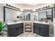 Elegant bathroom has and sinks, with mirrors and decorative lights at 5381 Waving Sage Dr, Las Vegas, NV 89149