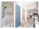 Elegant bathroom with a marble shower and stylish blue accent paneling at 5381 Waving Sage Dr, Las Vegas, NV 89149