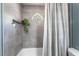 Stylish bathroom featuring tiled shower, niche, decorative window, and a shower curtain at 5381 Waving Sage Dr, Las Vegas, NV 89149