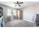Bright bedroom with a large window, carpet floors, closet, and storage cabinet, perfect for relaxation and organization at 5381 Waving Sage Dr, Las Vegas, NV 89149