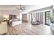 Primary bedroom featuring wood floors, vaulted ceilings, a king bed, and ample natural light from large windows at 5381 Waving Sage Dr, Las Vegas, NV 89149