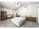 Spacious bedroom with vaulted ceilings, carpet, dual dressers, bed, and natural light, offering a tranquil setting at 5381 Waving Sage Dr, Las Vegas, NV 89149