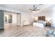 Open bedroom features a light dresser, a ceiling fan, and adjoins the kitchen at 5381 Waving Sage Dr, Las Vegas, NV 89149