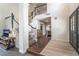 Welcoming foyer features a staircase, dark wood floors, and decorative glass front door at 5381 Waving Sage Dr, Las Vegas, NV 89149