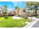 Charming two-story home boasts a lush green lawn, mature trees, and a three-car garage at 5381 Waving Sage Dr, Las Vegas, NV 89149
