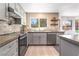 Modern kitchen featuring gray cabinets, concrete countertops, and stainless steel appliances at 5381 Waving Sage Dr, Las Vegas, NV 89149