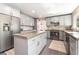 Bright kitchen with island, gray cabinets, and stainless steel appliances for a sleek, modern design at 5381 Waving Sage Dr, Las Vegas, NV 89149