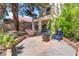 A patio with chairs, a fire pit, and an outdoor kitchen area offer a perfect space for relaxation at 5381 Waving Sage Dr, Las Vegas, NV 89149