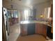 Open concept kitchen showcases a breakfast bar and connects the dining area with stainless steel refrigerator at 5429 Chela Dr, Las Vegas, NV 89120