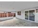Enclosed back patio with concrete flooring, leading to a spacious, fenced backyard at 5617 Reiter Ave, Las Vegas, NV 89108