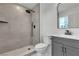 Modern bathroom with walk-in shower, dark fixtures, gray vanity at 5617 Reiter Ave, Las Vegas, NV 89108