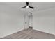 Bright bedroom features neutral carpet, a ceiling fan, and an open door at 5617 Reiter Ave, Las Vegas, NV 89108