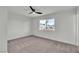 Bedroom featuring a ceiling fan and a large window overlooking the neighborhood at 5617 Reiter Ave, Las Vegas, NV 89108