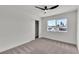Bedroom featuring carpet, a ceiling fan, and a large window with exterior views at 5617 Reiter Ave, Las Vegas, NV 89108