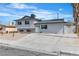 Exterior view of a two-story home featuring updated paint, landscaping, and driveway at 5617 Reiter Ave, Las Vegas, NV 89108