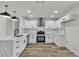 Bright kitchen features white cabinets, stainless steel appliances, and marble countertops at 5617 Reiter Ave, Las Vegas, NV 89108