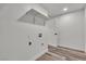 Functional laundry room featuring shelving, tile floors, and modern hookups at 5617 Reiter Ave, Las Vegas, NV 89108