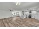 Open-concept living room featuring modern kitchen, fan and fireplace at 5617 Reiter Ave, Las Vegas, NV 89108