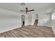 Spacious living area with wood-look flooring, neutral paint, and access to the upper level at 5617 Reiter Ave, Las Vegas, NV 89108