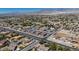 Expansive aerial view of a residential neighborhood with mountain views and tree-lined streets at 5851 Slate Rock Ct, Las Vegas, NV 89149