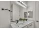 Bright bathroom featuring double sinks, white cabinets, and modern black fixtures at 5851 Slate Rock Ct, Las Vegas, NV 89149