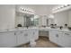 Bathroom featuring a large dual vanity, modern lighting, and wood flooring at 5851 Slate Rock Ct, Las Vegas, NV 89149