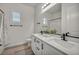 Bright bathroom featuring double sinks, white cabinets, and modern black fixtures at 5851 Slate Rock Ct, Las Vegas, NV 89149
