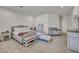 Spacious bedroom featuring neutral décor, a king-size bed, and a comfortable sitting area at 5851 Slate Rock Ct, Las Vegas, NV 89149
