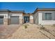 Attractive single-story home featuring a three-car garage and well-maintained desert landscape at 5851 Slate Rock Ct, Las Vegas, NV 89149