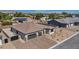 Beautiful exterior featuring a two-car garage and professionally landscaped front yard at 5851 Slate Rock Ct, Las Vegas, NV 89149