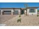 Charming single-story home with a three-car garage and low-maintenance desert landscaping at 5851 Slate Rock Ct, Las Vegas, NV 89149