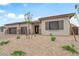 Charming single-story home with desert landscaping, complemented by a three-car garage at 5851 Slate Rock Ct, Las Vegas, NV 89149