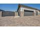 Attached garage with brick trim and black iron fence in front of a paver driveway at 5851 Slate Rock Ct, Las Vegas, NV 89149